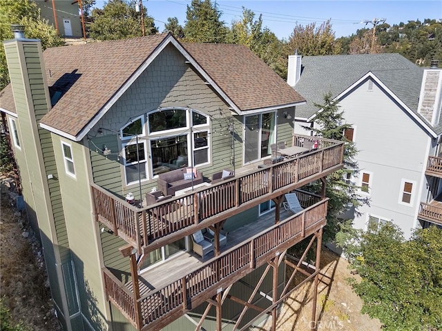 26845 Modoc Ln, Lake Arrowhead, CA 92352 - rear view of property featuring a chimney, a shingled roof, a wooden deck, and an outdoor hangout area