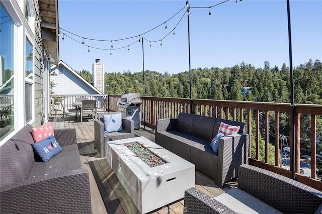 26845 Modoc Ln, Lake Arrowhead, CA 92352 - wooden terrace featuring an outdoor living space with a fire pit, a grill, outdoor dining space, and a wooded view
