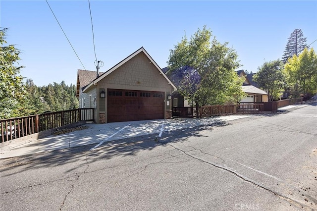 26845 Modoc Ln, Lake Arrowhead, CA 92352 - view of front of house featuring driveway and an attached garage