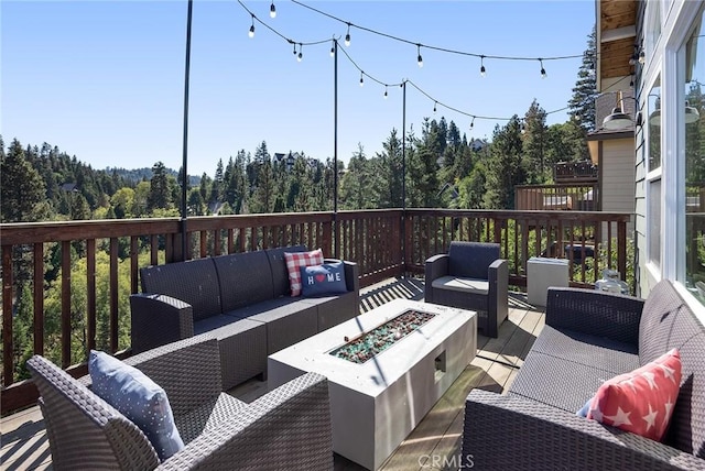 26845 Modoc Ln, Lake Arrowhead, CA 92352 - wooden deck with an outdoor living space with a fire pit and a view of trees