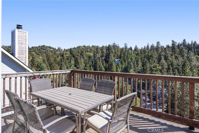 26845 Modoc Ln, Lake Arrowhead, CA 92352 - wooden deck featuring a forest view and outdoor dining area