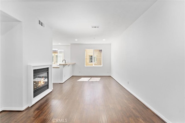 456 W Linden Dr, Orange, CA 92865 - unfurnished living room with wood finished floors, heating unit, and a glass covered fireplace