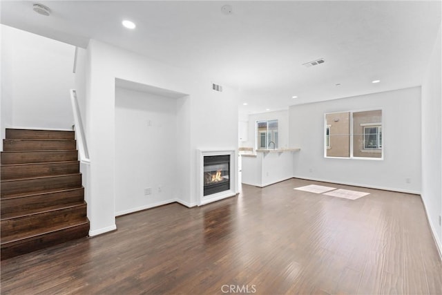 456 W Linden Dr, Orange, CA 92865 - unfurnished living room featuring stairs, dark wood finished floors, a glass covered fireplace, and recessed lighting