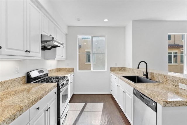 456 W Linden Dr, Orange, CA 92865 - kitchen with appliances with stainless steel finishes, under cabinet range hood, dark wood-style floors, light countertops, and a peninsula