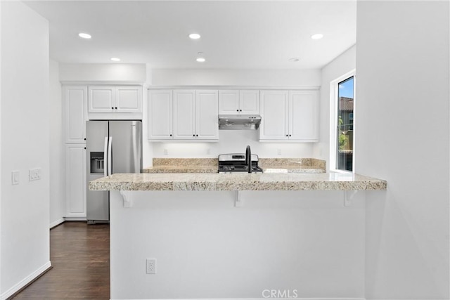 456 W Linden Dr, Orange, CA 92865 - kitchen with stainless steel fridge, stove, under cabinet range hood, a breakfast bar area, and white cabinetry