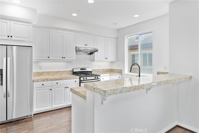 456 W Linden Dr, Orange, CA 92865 - kitchen featuring stainless steel appliances, under cabinet range hood, a kitchen breakfast bar, white cabinetry, and recessed lighting
