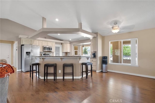 9525 Cambria Ct, Phelan, CA 92371 - kitchen with stainless steel appliances, a kitchen breakfast bar, a ceiling fan, lofted ceiling, and plenty of natural light