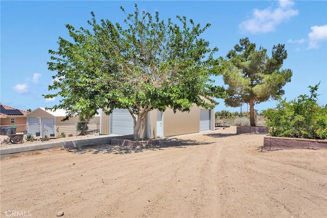 9525 Cambria Ct, Phelan, CA 92371 - view of front of property with a detached garage and an outdoor structure
