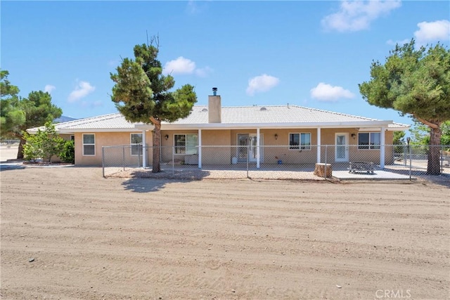 9525 Cambria Ct, Phelan, CA 92371 - rear view of house with a chimney and stucco siding