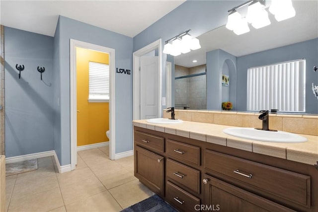 9525 Cambria Ct, Phelan, CA 92371 - full bathroom with a shower stall, double vanity, and tile patterned flooring