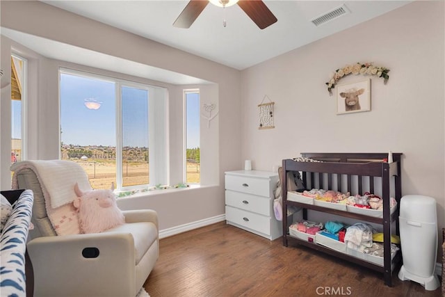 9525 Cambria Ct, Phelan, CA 92371 - bedroom with wood finished floors, a nursery area, and a ceiling fan