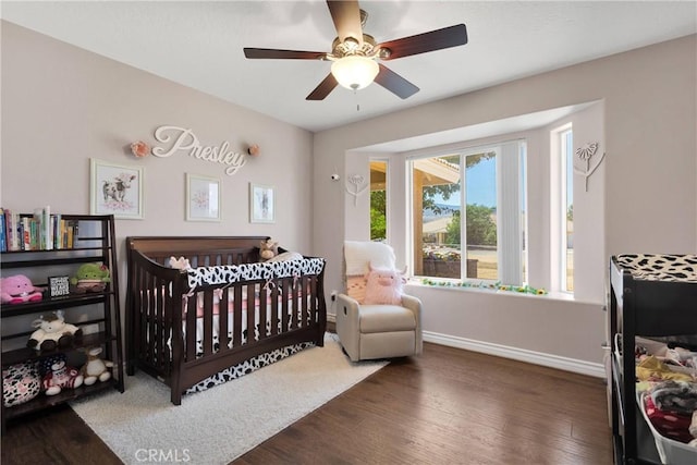 9525 Cambria Ct, Phelan, CA 92371 - bedroom featuring wood finished floors, a crib, and ceiling fan