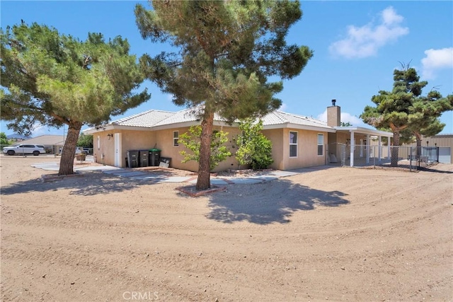 9525 Cambria Ct, Phelan, CA 92371 - view of front of property with stucco siding and a chimney