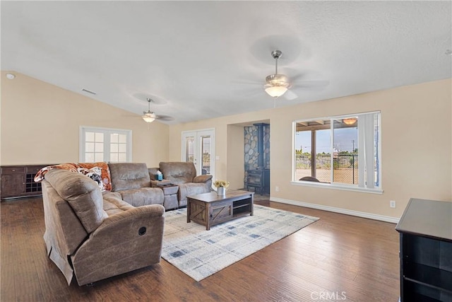 9525 Cambria Ct, Phelan, CA 92371 - living area featuring a ceiling fan, a wood stove, dark wood-style flooring, and lofted ceiling