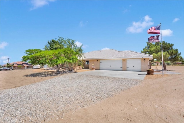 9525 Cambria Ct, Phelan, CA 92371 - view of front facade featuring driveway, an attached garage, and stucco siding