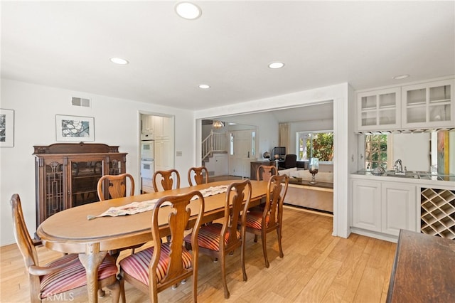 5230 Harbour Heights Ct, San Diego, CA 92109 - dining room with recessed lighting, light wood-style flooring, and stairway