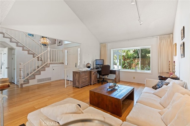 5230 Harbour Heights Ct, San Diego, CA 92109 - living room with hardwood / wood-style floors, stairway, high vaulted ceiling, a desk, and a textured ceiling