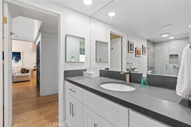 5230 Harbour Heights Ct, San Diego, CA 92109 - full bath featuring vanity, wood finished floors, a shower with shower door, and recessed lighting