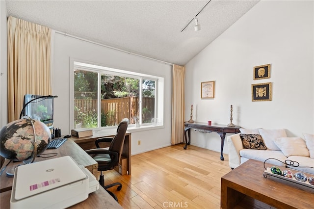5230 Harbour Heights Ct, San Diego, CA 92109 - office area featuring rail lighting, vaulted ceiling, light wood-type flooring, and a textured ceiling