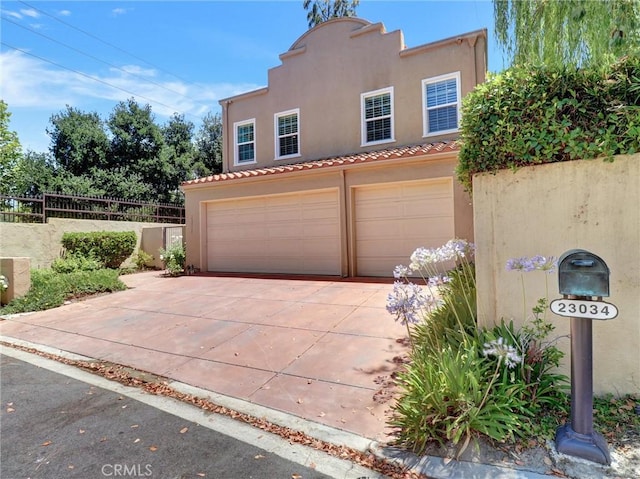 23034 Park Este, Calabasas, CA 91302 - view of front of house featuring stucco siding, an attached garage, driveway, and a tile roof