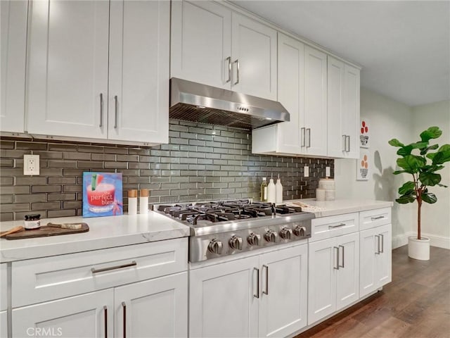 23034 Park Este, Calabasas, CA 91302 - kitchen with under cabinet range hood, stainless steel gas stovetop, white cabinetry, dark wood-type flooring, and tasteful backsplash
