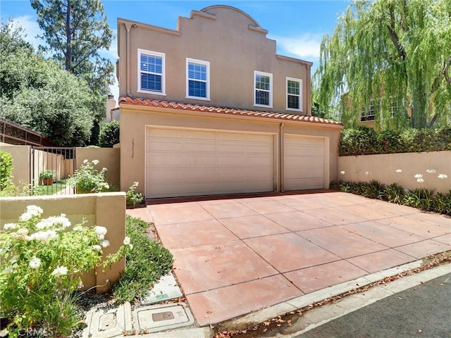 23034 Park Este, Calabasas, CA 91302 - mediterranean / spanish home with an attached garage, stucco siding, a tiled roof, and driveway