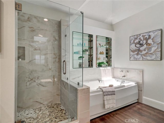 23034 Park Este, Calabasas, CA 91302 - bathroom with a bath, a stall shower, and wood finished floors