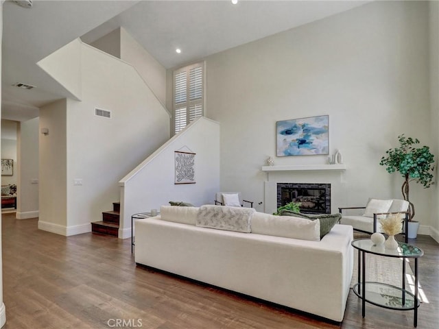 23034 Park Este, Calabasas, CA 91302 - living room featuring a fireplace, stairs, wood finished floors, a towering ceiling, and recessed lighting