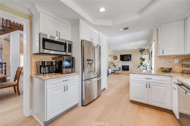 6140 Meadow Lark Dr, La Verne, CA 91750 - kitchen with appliances with stainless steel finishes, light wood-type flooring, white cabinetry, and recessed lighting