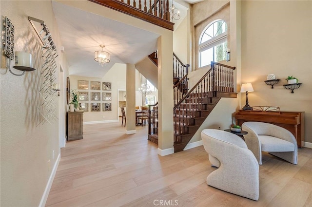 6140 Meadow Lark Dr, La Verne, CA 91750 - foyer entrance featuring a chandelier, a high ceiling, wood finished floors, and stairs