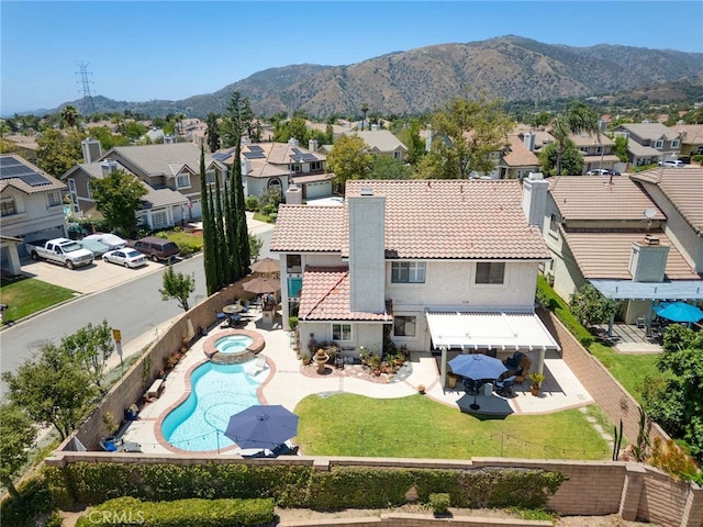 6140 Meadow Lark Dr, La Verne, CA 91750 - rear view of property featuring a residential view, a fenced backyard, a chimney, and a tiled roof
