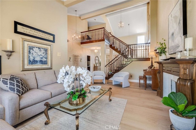 6140 Meadow Lark Dr, La Verne, CA 91750 - living room with a chandelier, stairs, wood finished floors, and high vaulted ceiling