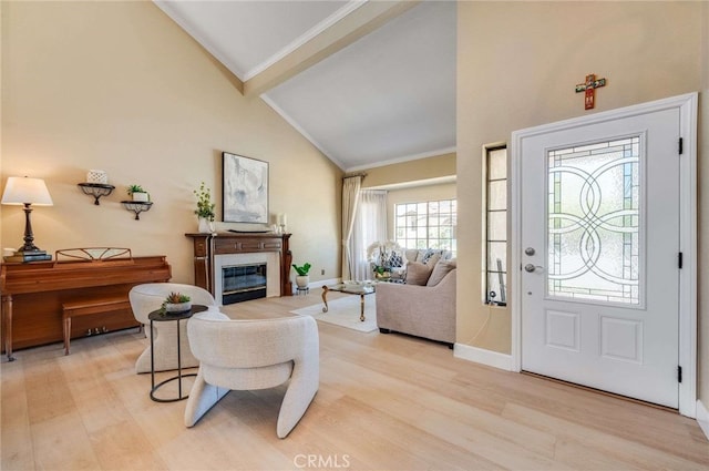 6140 Meadow Lark Dr, La Verne, CA 91750 - entryway with light wood-style floors, a glass covered fireplace, beam ceiling, ornamental molding, and high vaulted ceiling