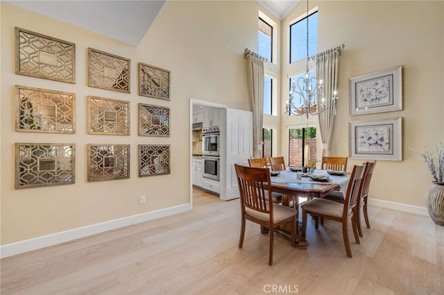 6140 Meadow Lark Dr, La Verne, CA 91750 - dining space featuring a towering ceiling, healthy amount of natural light, a chandelier, and light wood-type flooring