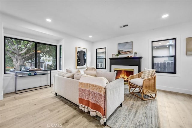 57 S Grand Oaks Ave, Pasadena, CA 91107 - living room with light wood-style flooring, a warm lit fireplace, and recessed lighting
