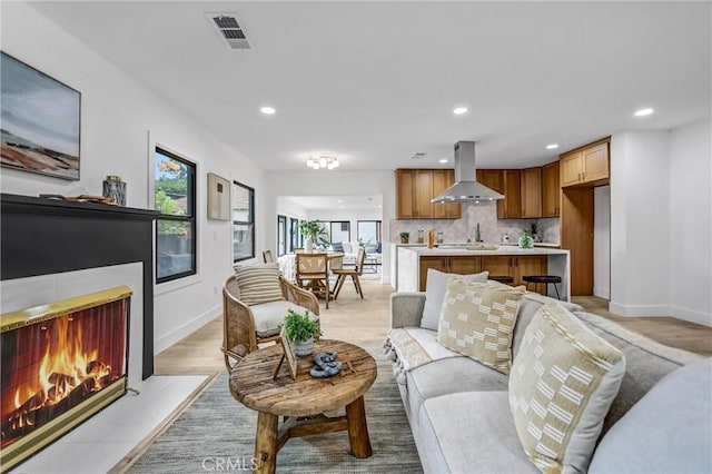 57 S Grand Oaks Ave, Pasadena, CA 91107 - living room featuring a lit fireplace, recessed lighting, and light wood finished floors