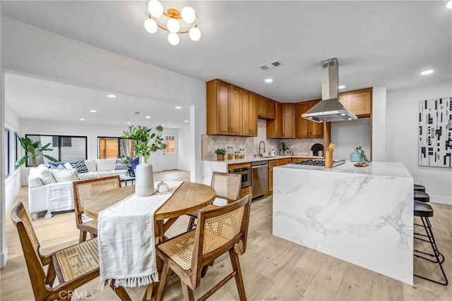 57 S Grand Oaks Ave, Pasadena, CA 91107 - kitchen featuring island range hood, appliances with stainless steel finishes, light wood finished floors, backsplash, and recessed lighting