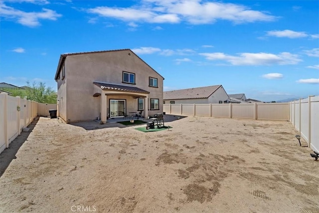 16814 Desert Star St, Victorville, CA 92394 - back of property with stucco siding, a fenced backyard, and a patio area