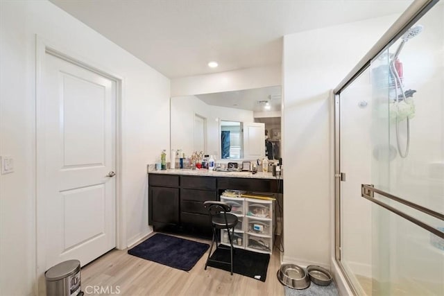 16814 Desert Star St, Victorville, CA 92394 - full bathroom featuring a shower stall, wood finished floors, vanity, and recessed lighting