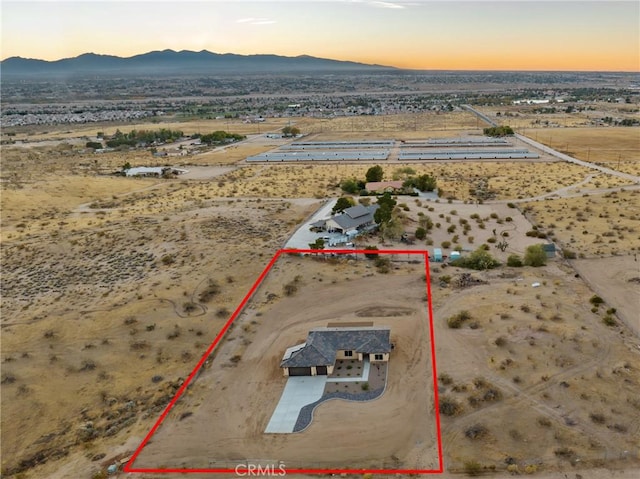 11228 Mockingbird, Apple Valley, CA 92308 - aerial view at dusk of view of desert landscape, property parcel outlined, a mountain view, and a view of rural / pastoral area