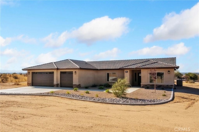 11228 Mockingbird, Apple Valley, CA 92308 - view of front of property featuring stucco siding, an attached garage, concrete driveway, a tiled roof, and stone siding