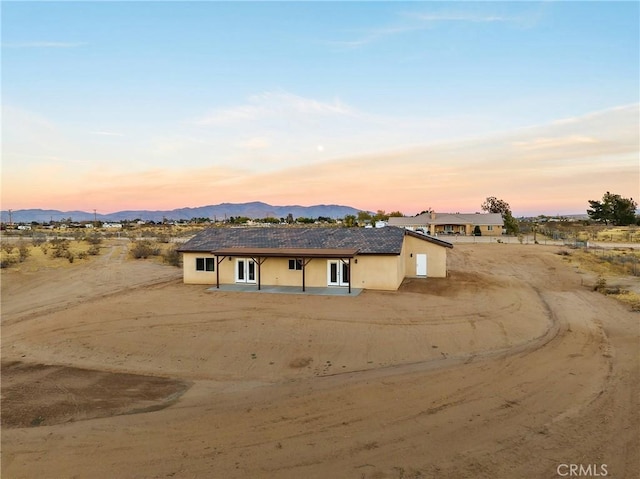 11228 Mockingbird, Apple Valley, CA 92308 - view of front of property featuring a mountain view, stucco siding, and a patio area