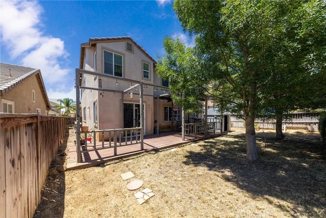 26 Billings Ave, Beaumont, CA 92223 - back of house with stucco siding, a fenced backyard, and a wooden deck