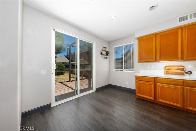 26 Billings Ave, Beaumont, CA 92223 - kitchen featuring dark wood-style floors, tile counters, and brown cabinetry