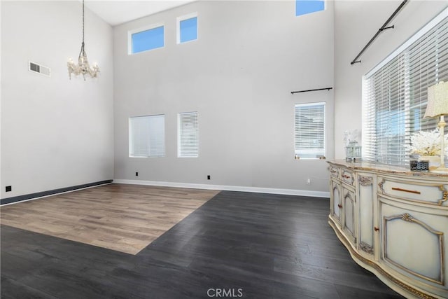 26 Billings Ave, Beaumont, CA 92223 - unfurnished living room with a chandelier, a high ceiling, and dark wood-style floors