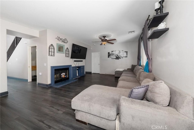 26 Billings Ave, Beaumont, CA 92223 - living room with a ceiling fan, dark wood-style floors, a fireplace with raised hearth, and stairway