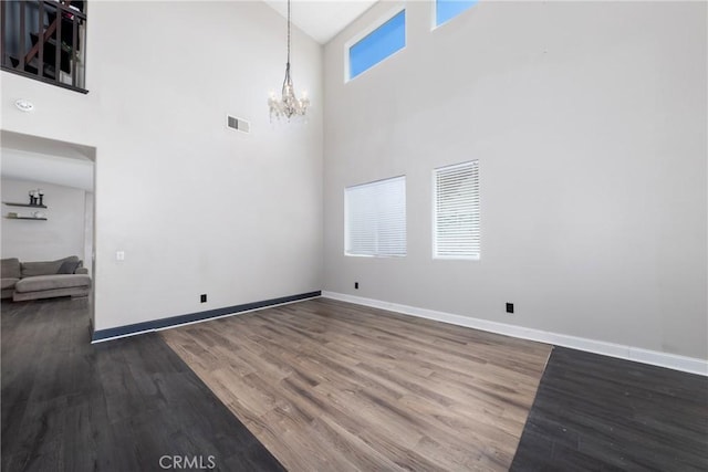 26 Billings Ave, Beaumont, CA 92223 - empty room featuring a chandelier, high vaulted ceiling, and wood finished floors