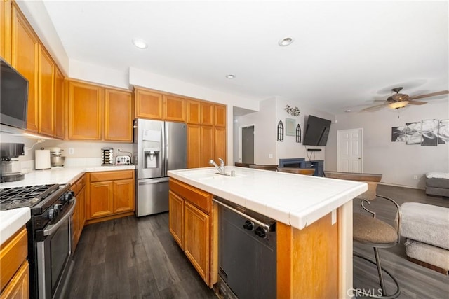26 Billings Ave, Beaumont, CA 92223 - kitchen featuring stainless steel refrigerator with ice dispenser, range with gas stovetop, dishwasher, tile countertops, and open floor plan