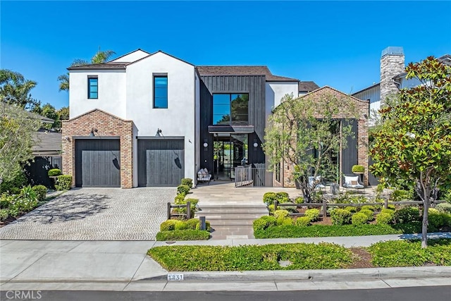 1831 Newport Hills Dr E, Newport Beach, CA 92660 - view of front of property featuring decorative driveway, an attached garage, brick siding, and stucco siding