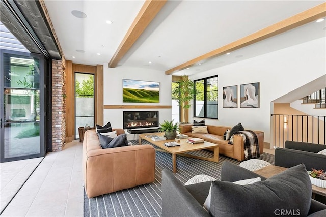 1831 Newport Hills Dr E, Newport Beach, CA 92660 - tiled living room featuring a glass covered fireplace, healthy amount of natural light, beamed ceiling, recessed lighting, and stairs
